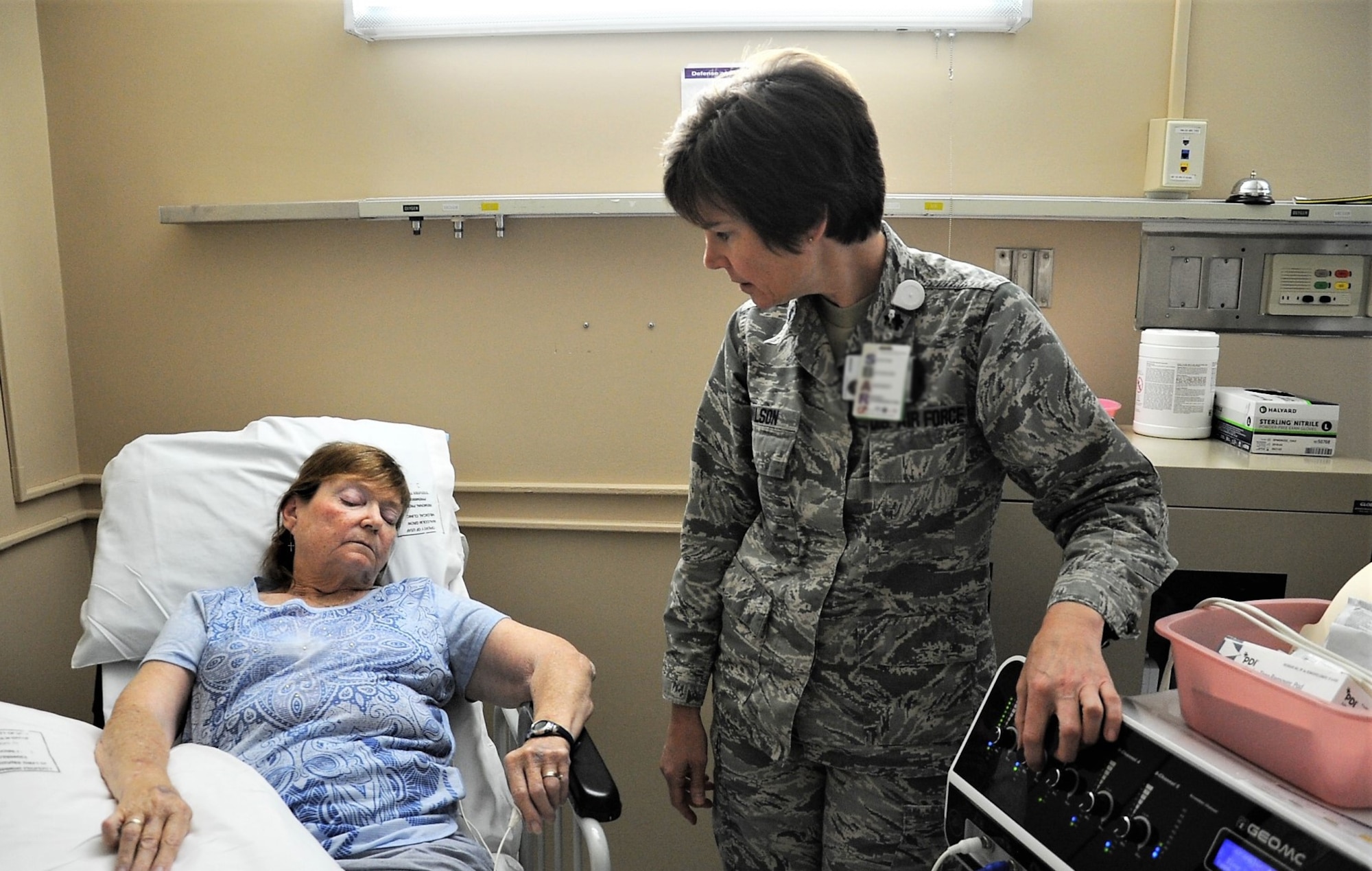 Lt. Col Candy Wilson, 779th Medical Group nurse practitioner, increases the electrical stimulation voltage of a Calmare pain therapy medical device while treating a patient using Nerve Scrambler Therapy May 30, 2017 at Joint Base Andrews, Md. The patients’ treatments vary from 20-60 minutes per session. (U.S. Air Force photo by Staff Sgt. Joe Yanik. This photo has been modified to protect PII)
