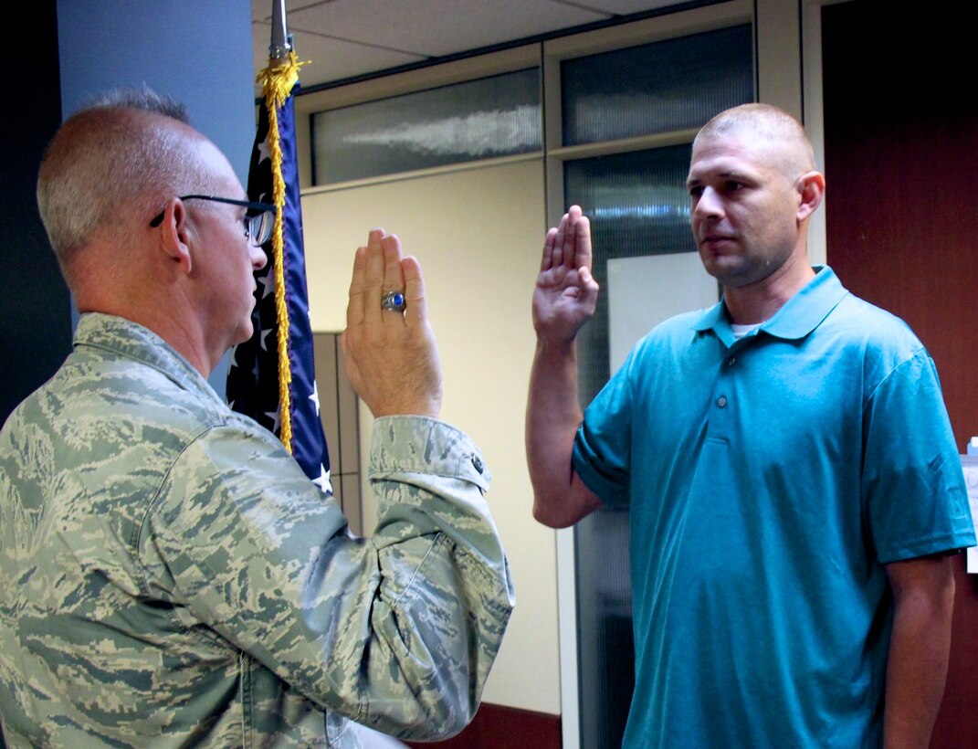 After serving his time in the United States Marines, Corey Ingram talked with the 932nd Airlift Wing Recruiting Service and decided to cross over to the Air Force Reserve Command and the "Gateway Wing" near Saint Louis.  He took the oath of enlistment a second time with Lt. Col Stan Paregien doing the honors on June 7, 2017, at Scott Air Force Base, Illinois.  The unit is part of 22nd Air Force, under Air Force Reserve Command.  Others interested in joining may contact the recruiters at (618)-229-7522.  (U.S. Air Force photo by Tech. Sgt. Sara Seibel)