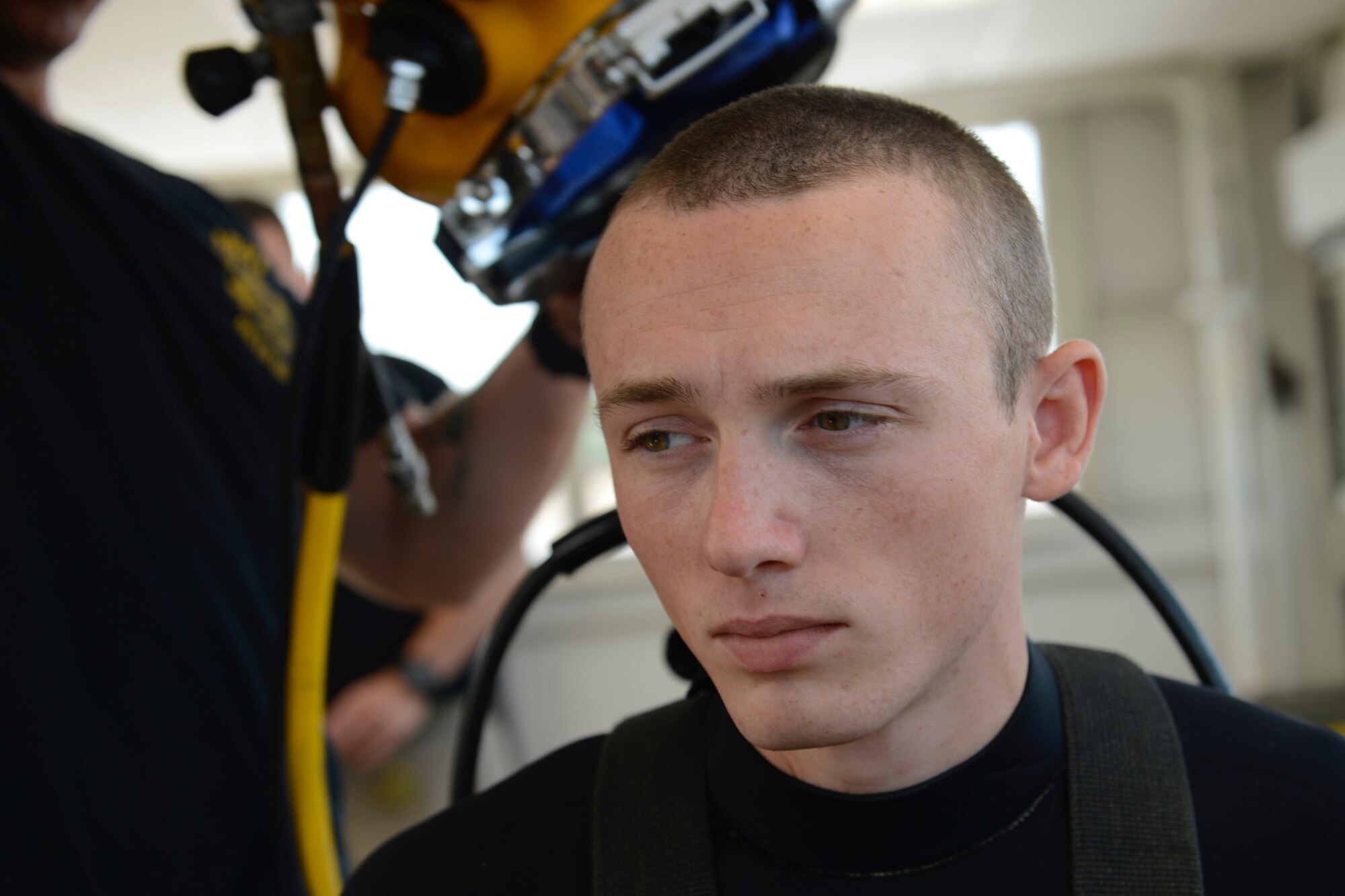 U.S. Army Spc. Michael Brown, 30th Engineer Battalion, 20th Eng. Brigade, 74th Eng. Dive Detachment salvage diver, dons his gear during dive-tank training at Joint Base Langley-Eustis, Va., June 6, 2017. Army divers support maritime missions by conducting underwater construction and demolition. (U.S. Air Force photo/Airman 1st Class Kaylee Dubois)