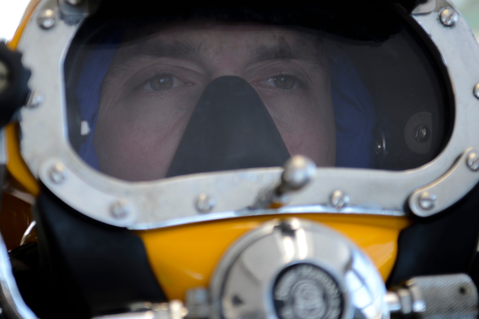 U.S. Army Spc. Michael Brown, 30th Engineer Battalion, 20th Eng. Brigade, 74th Engineer Eng. Dive Detachment salvage diver, secures his surface supply helmet during dive-tank training at Joint Base Langley-Eustis, Va., June 6, 2017.  The surface supply helmet allows for divers to submerge with continuous oxygen and communication. (U.S. Air Force photo/Airman 1st Class Kaylee Dubois)