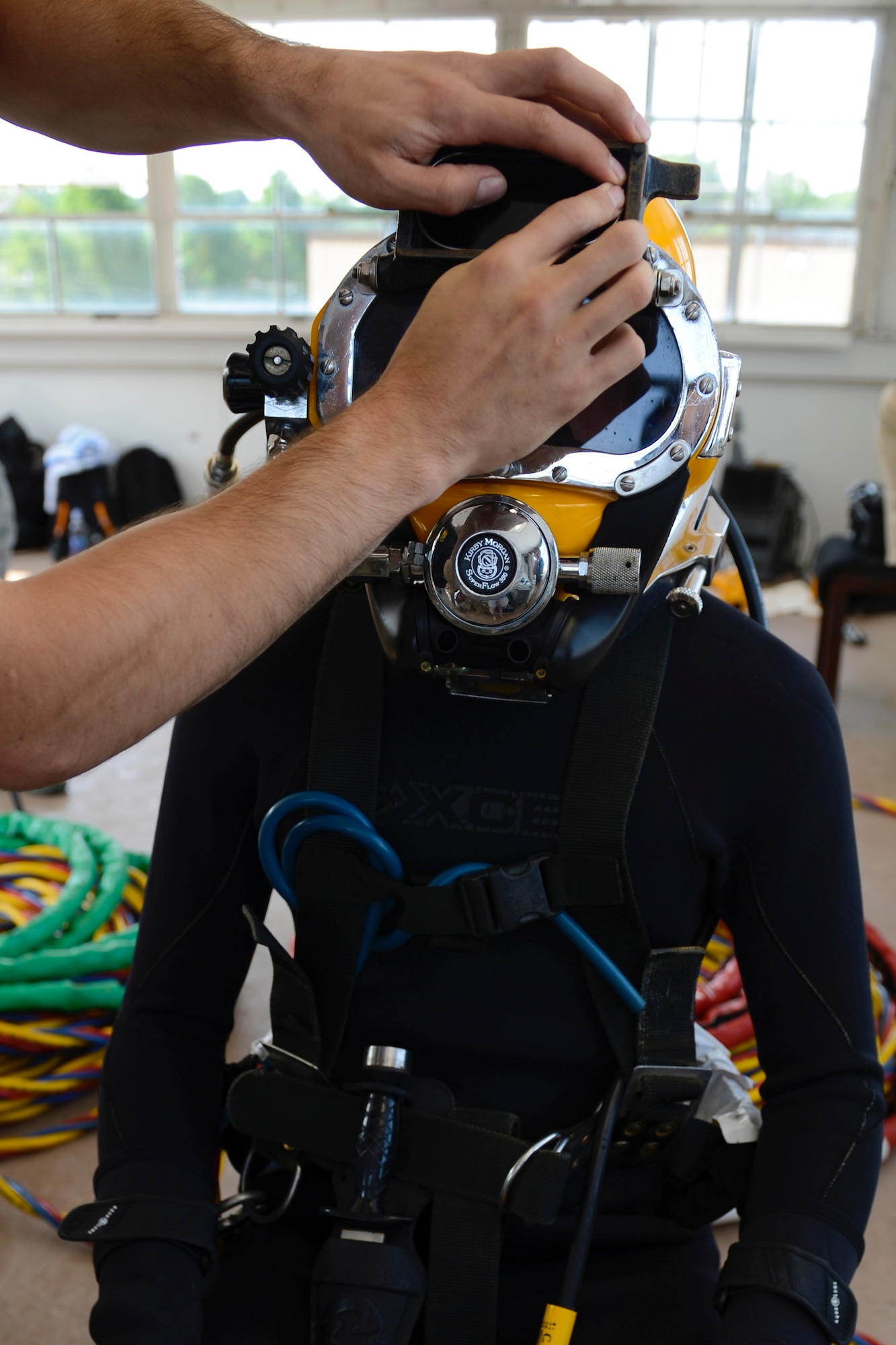 U.S. Army Spc. Michael Brown, 30th Engineer Battalion, 20th Eng. Brigade, 74th Eng. Dive Detachment salvage diver, is checked prior to dive-tank training at Joint Base Langley-Eustis, Va., June 6, 2017. Safety checks are conducted on all equipment before each dive to mitigate any possible risks. (U.S. Air Force photo/Airman 1st Class Kaylee Dubois)
