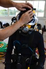 U.S. Army Spc. Michael Brown, 30th Engineer Battalion, 20th Eng. Brigade, 74th Eng. Dive Detachment salvage diver, is checked prior to dive-tank training at Joint Base Langley-Eustis, Va., June 6, 2017. Safety checks are conducted on all equipment before each dive to mitigate any possible risks. (U.S. Air Force photo/Airman 1st Class Kaylee Dubois)