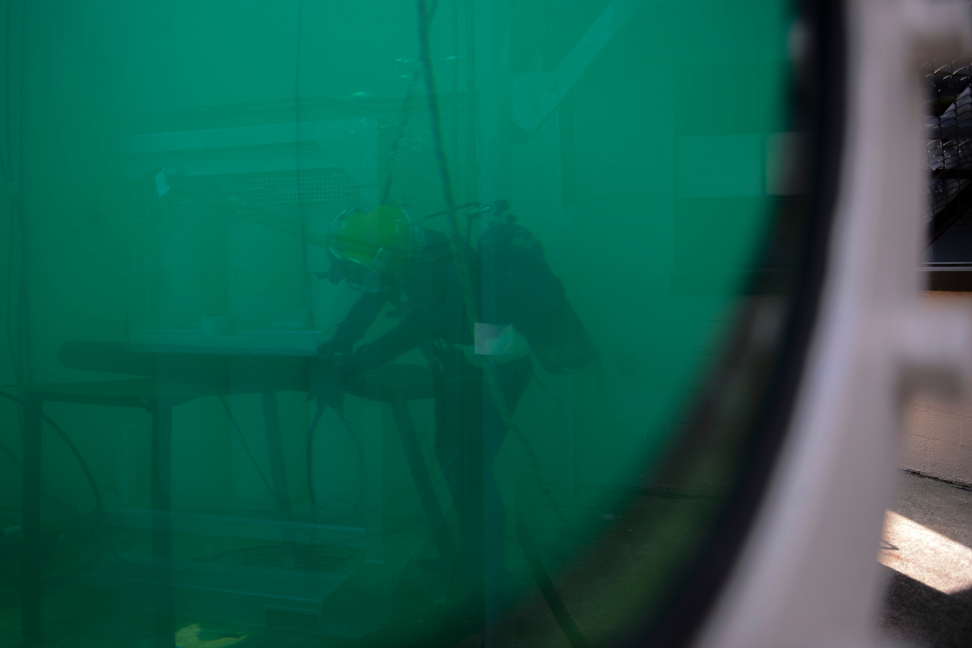 U.S. Army Spc. Michael Brown, 30th Engineer Battalion, 20th Eng. Brigade, 74th Eng. Dive Detachment salvage diver, welds metal patches onto a frame during dive-tank training at Joint Base Langley-Eustis, Va., June 6, 2017. During the training, Brown performed cuts and welds using specialized tools that require a surface-side hydraulic pump instead of electricity to prevent a voltage discharge underwater. (U.S. Air Force photo/Airman 1st Class Kaylee Dubois)