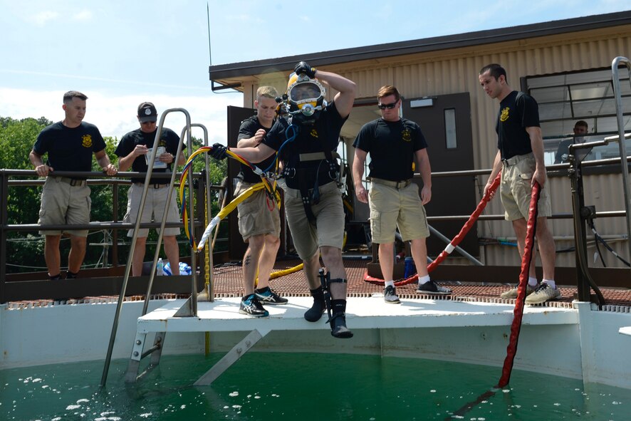 U.S. Army Pfc. James Lewis, 30th Engineer Battalion, 20th Eng. Brigade, 74th Eng. Dive Detachment second-class diver, jumps into a dive-tank during training at Joint Base Langley-Eustis, Va., June 6, 2017. Lewis was a stand-by diver during the training, which is required for each dive in case a fellow diver needs rescuing. (U.S. Air Force photo/Airman 1st Class Kaylee Dubois)