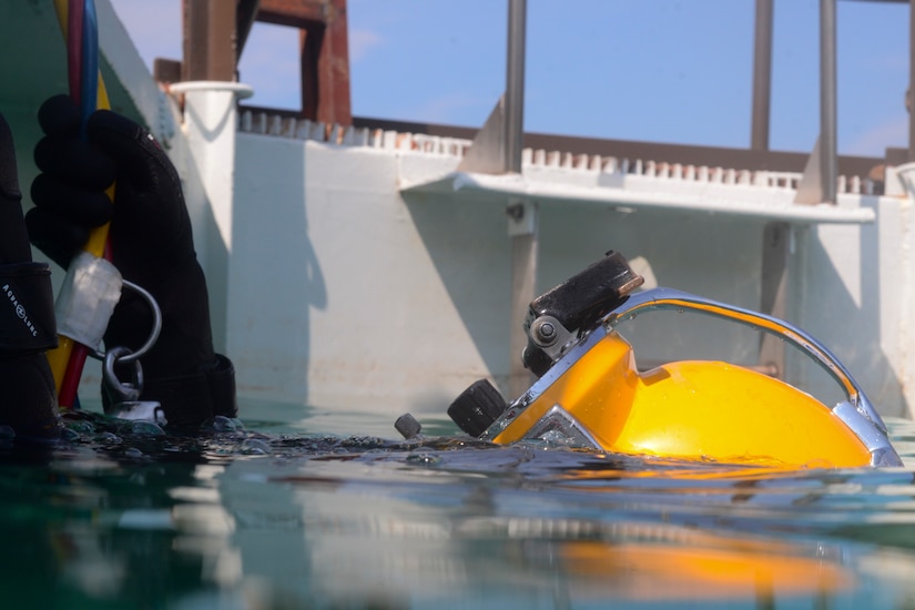 U.S. Army Spc. Michael Brown, 30th Engineer Battalion, 20th Eng. Brigade, 74th Eng. Dive Detachment salvage diver, lingers at the surface of a dive-tank during training at Joint Base Langley-Eustis, Va., June 6, 2017. Surface-dive equipment is used for long dives that require constant communication as well as and head and eye protection. (U.S. Air Force photo/Airman 1st Class Kaylee Dubois)