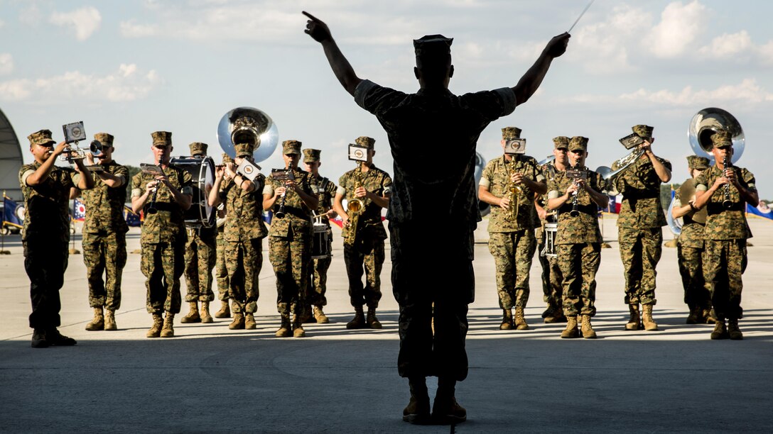 A conductor directs the 2nd Marine Aircraft Wing band during a deactivation ceremony for Marine Tactical Electronic Warfare Squadron 4 at Marine Corps Air Station Cherry Point, N.C., June 2, 2017. The squadron deactivated after supporting the 2nd Marine Aircraft wing for 35 years. Marine Corps photo by Lance Cpl. Jailine L. Martinez
