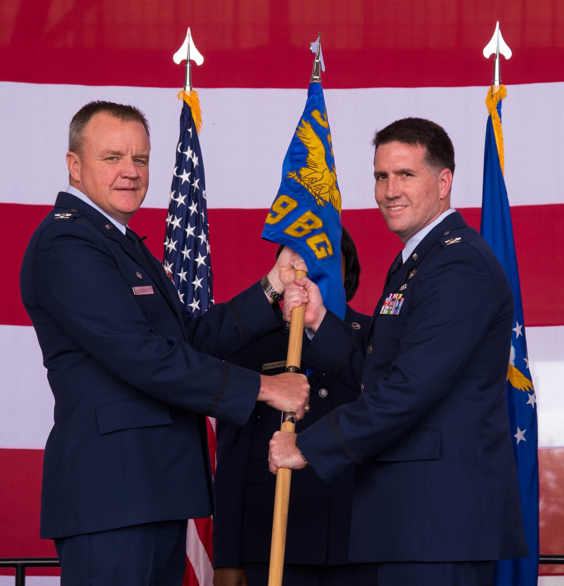 Col. Bruce Cox, 307th Bomb Wing commander, presents the guidon of the 489th Bomb Group to Col. Michael McClanahan during a change of command ceremony at Dyess Air Force Base, Texas, June 3, 2017. This is the unit’s first change of command since it was reactivated in 2015. (U.S. Air Force photo by Staff Sgt. Jason McCasland/Released)