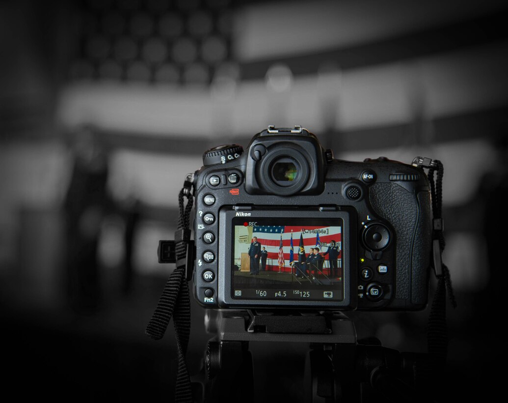 A video camera records the change of command ceremony at Dyess Air Force Base, Texas, June 3, 2017. The change of command Ceremony dates back to the 18th Century, where unit flags were handed off between the outgoing and incoming commanders. The ceremony concludes with the new commander stating to the presiding official, “Sir, I assume command.” (U.S. Air Force photo by Staff Sgt. Jason McCasland/Released)