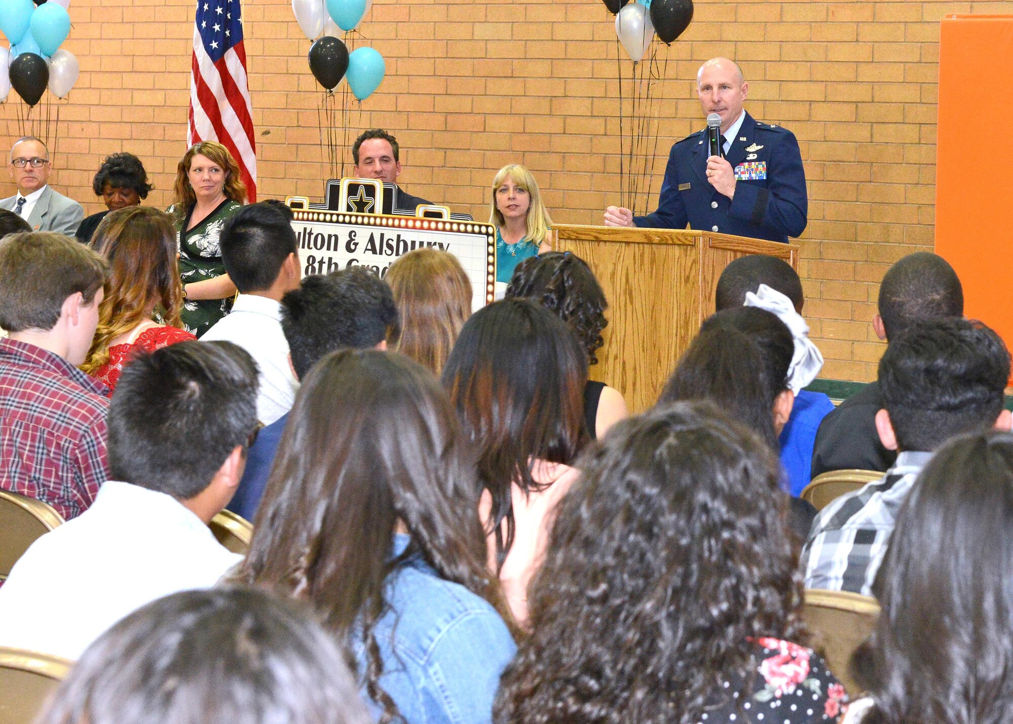 Brig. Gen. Carl Schaefer, 412th Test Wing commander, addresses eighth-graders at a promotion ceremony for Fulton and Alsbury Academy of Arts and Engineering students in Lancaster, California June 5. (U.S. Air Force photo by Kenji Thuloweit)