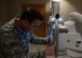 Airman 1st Class Brandon Ibe, 56th Medical Support Squadron diagnostic imaging technician, prepares a patient for an X-ray scan June 5, 2017, at Luke Air Force Base, Ariz. The radiology clinic specializes in X-rays, fluoroscopy, MRIs, ultrasound and mammograms. (U.S. Air Force photo by Senior Airman James Hensley)