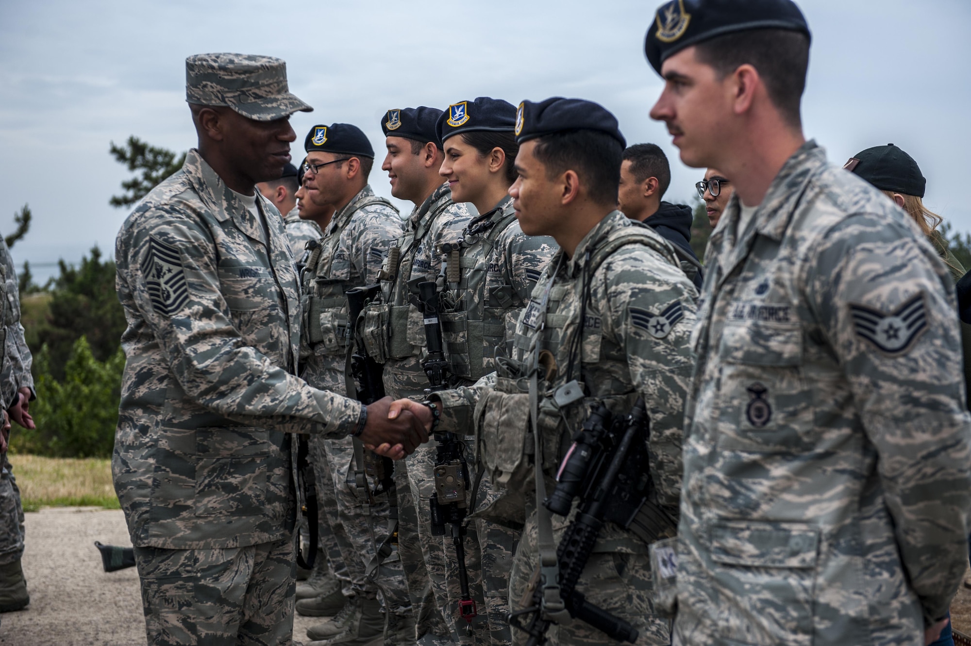 Chief Master Sgt. of the Air Force Kaleth O. Wright shakes hands with an Airman assigned to the 8th Security Forces Squadron as he takes a tour of the squadrons at Kunsan Air Base, Republic of Korea, June 6, 2017. 8th SFS showcased their role in the first priority of Wolf Pack’s mission to, “Defend the Base.” (U.S. Air Force photo by Senior Airman Colville McFee/Released)