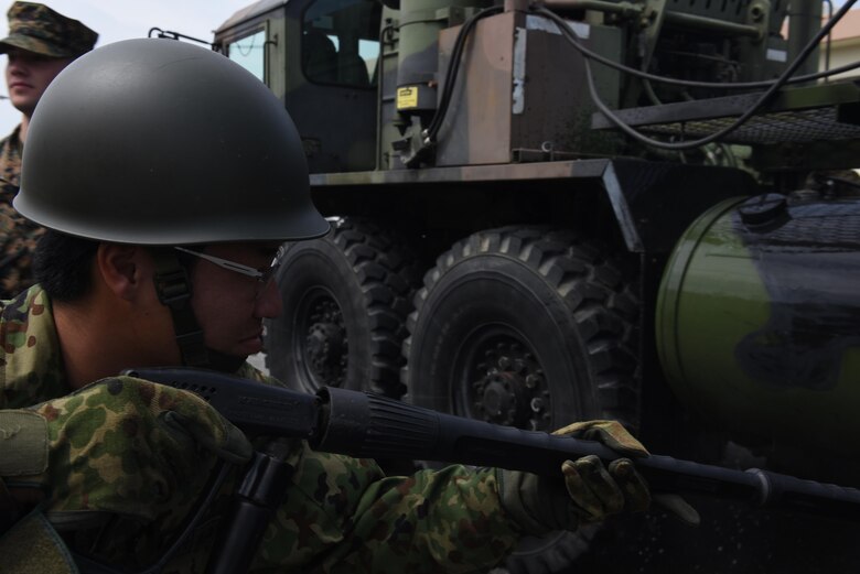 A member of the Japan Ground Self-defense Force decontaminates an MIM-104 Patriot missile system, during a training exercise, May 18, 2017, at Kadena Air Base, Japan. The operation was spent learning ways to improve operations and supplying guidance to help improve processes of the other units. (U.S. Air Force photo by Senior Airman Nick Emerick) 