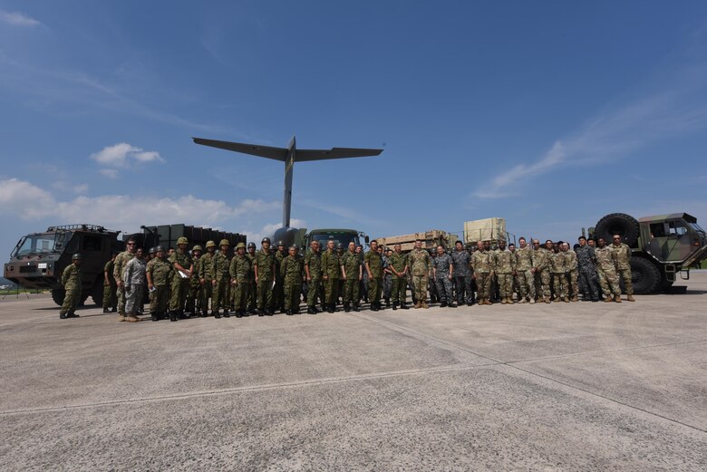 Japan Ground Self-defense Force, 1-1 Air Defense Artillery battalion and 18th Wing members pose for a group photo at the end of a two-day chemical, biological, radiological and nuclear defense exercise May 18, 2017, at Kadena Air Base, Japan. The operation was spent learning ways to improve operations and supplying guidance to help improve processes of the other units. (U.S. Air Force photo by Senior Airman Nick Emerick) 