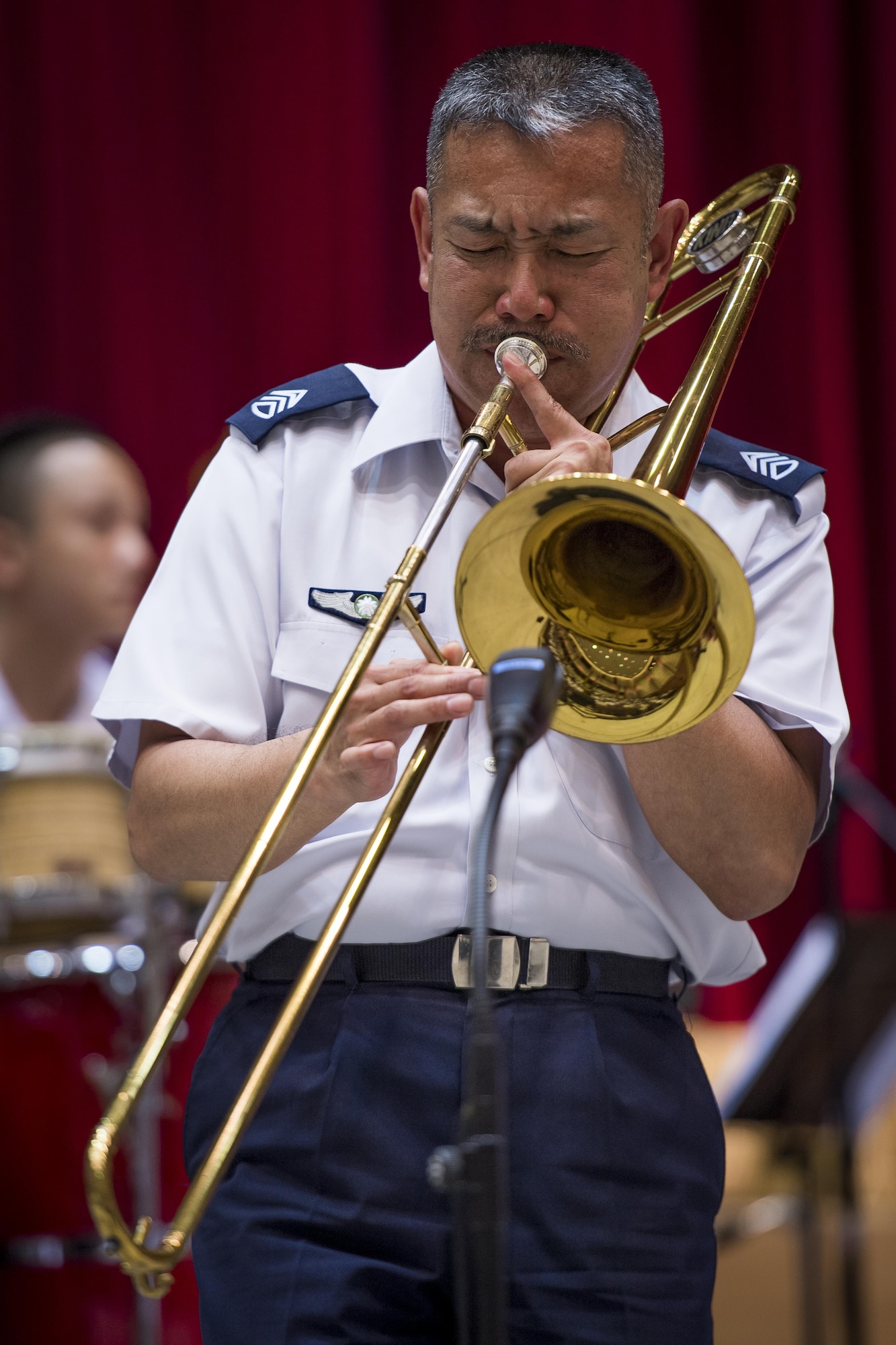 Japan Air Self Defense Force Chief Master Sgt. Takahiro Arai, JASDF Central Band bandsman, preforms a trombone solo during a Joint Big Band Concert, June 7, 2017, at the Japanese Ministry of Defense, Tokyo, Japan. The concert marked the first time five separate bands from Japan and U.S. forces have come together as one. By highlighting the strong alliance and friendship shared between the Japanese and U.S. forces, the concert demonstrated how music can help strengthen cultural ties. (U.S. Air Force photo by Airman 1st Class Donald Hudson)