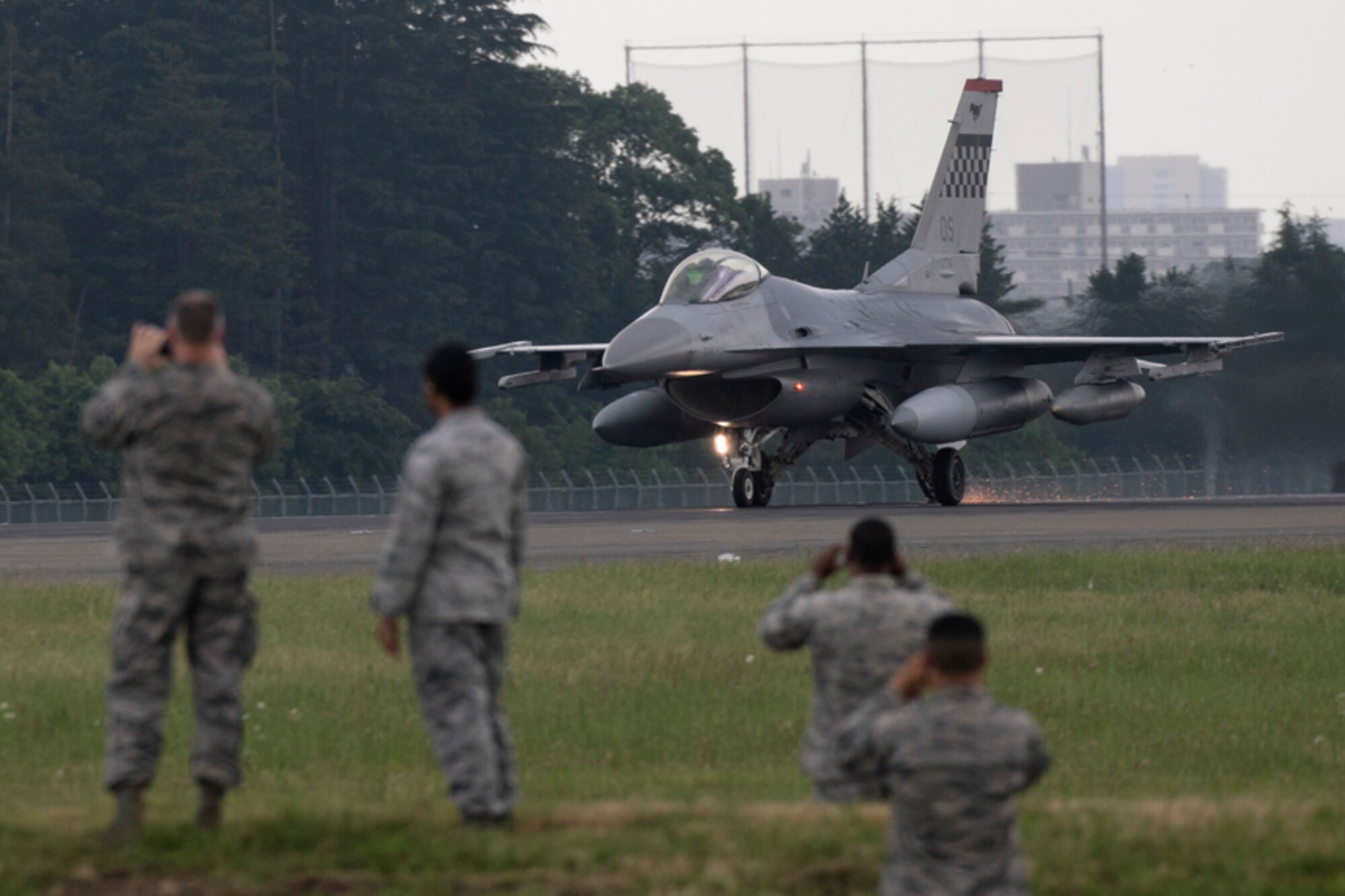Airmen with the 374th Civil Engineer Squadron observe an F-16 Fighting Falcon test an Aircraft Arresting System, June 1, 2017, Yokota Air Base, Japan. The AAS is required to be tested annually. Airmen from the 374 CES and 374th Operations Support Squadron are responsible for setting up the system and logging any deficiencies during the test. (U.S. Air Force photo by Yasuo Osakabe)