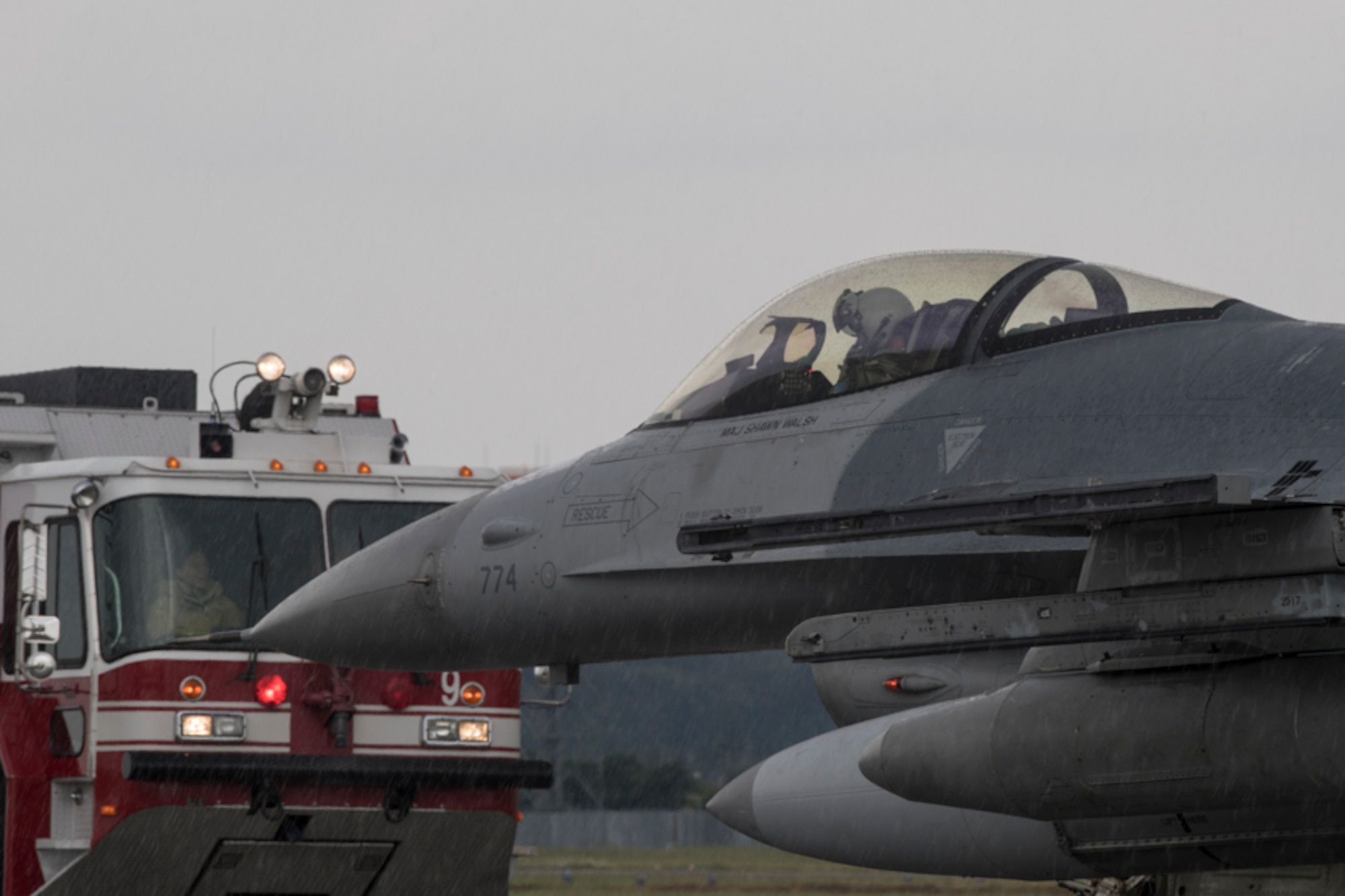 Yokota firefighters with the 374th Civil Engineer Squadron observes an F-16 Fighting Falcon assigned to the 36th Fighter Squadron, Osan Air Base, Republic of Korea after executing the Aircraft Arresting System test at Yokota Air Base, Japan, June 1, 2017. The system went through an annual certification test to ensure its operability following installation by the 374 CES power productions shop. (U.S. Air Force photo by Yasuo Osakabe)