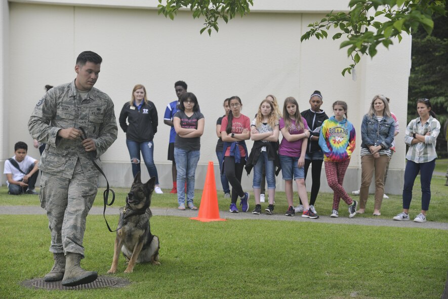 U.S. Air Force Staff Sgt. Charles Sena, a 35th Security Forces Squadron military working dog handler, demonstrates MWD Karo’s discipline with a variety of commands during a security forces immersion with kids from the teen and youth centers at Misawa Air Base, Japan, June 8, 2017. The event is part of a project by the Boys and Girls Club curriculum for the Misawa Teen Center implements into the different clubs they offer. The focus helped establish a relationship between teens and security forces. (U.S. Air Force photo by Capt. Samantha Morrison)