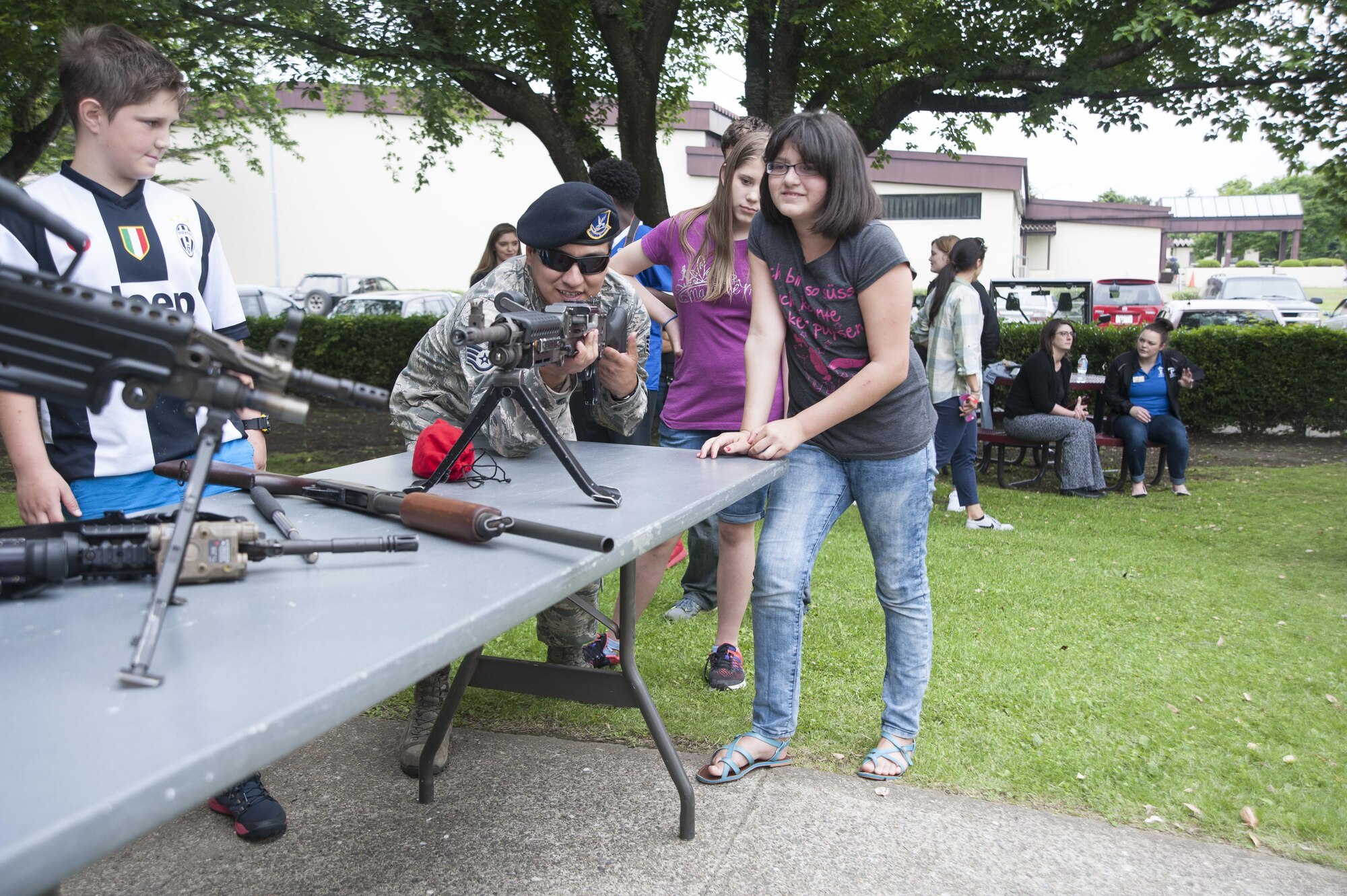 U.S. Air Force Staff Sgt. Eric Ramon, a 35th Security Forces Squadron combat arms instructor, demonstrates how to properly hold the M-240B machine gun during a security forces immersion with kids from the teen and youth centers at Misawa Air Base, Japan, June 8, 2017.  Twenty children attended the event and received an insider’s look at what the 35th SFS member’s job entails. (U.S. Air Force photo by Staff Sgt. Melanie A. Hutto)