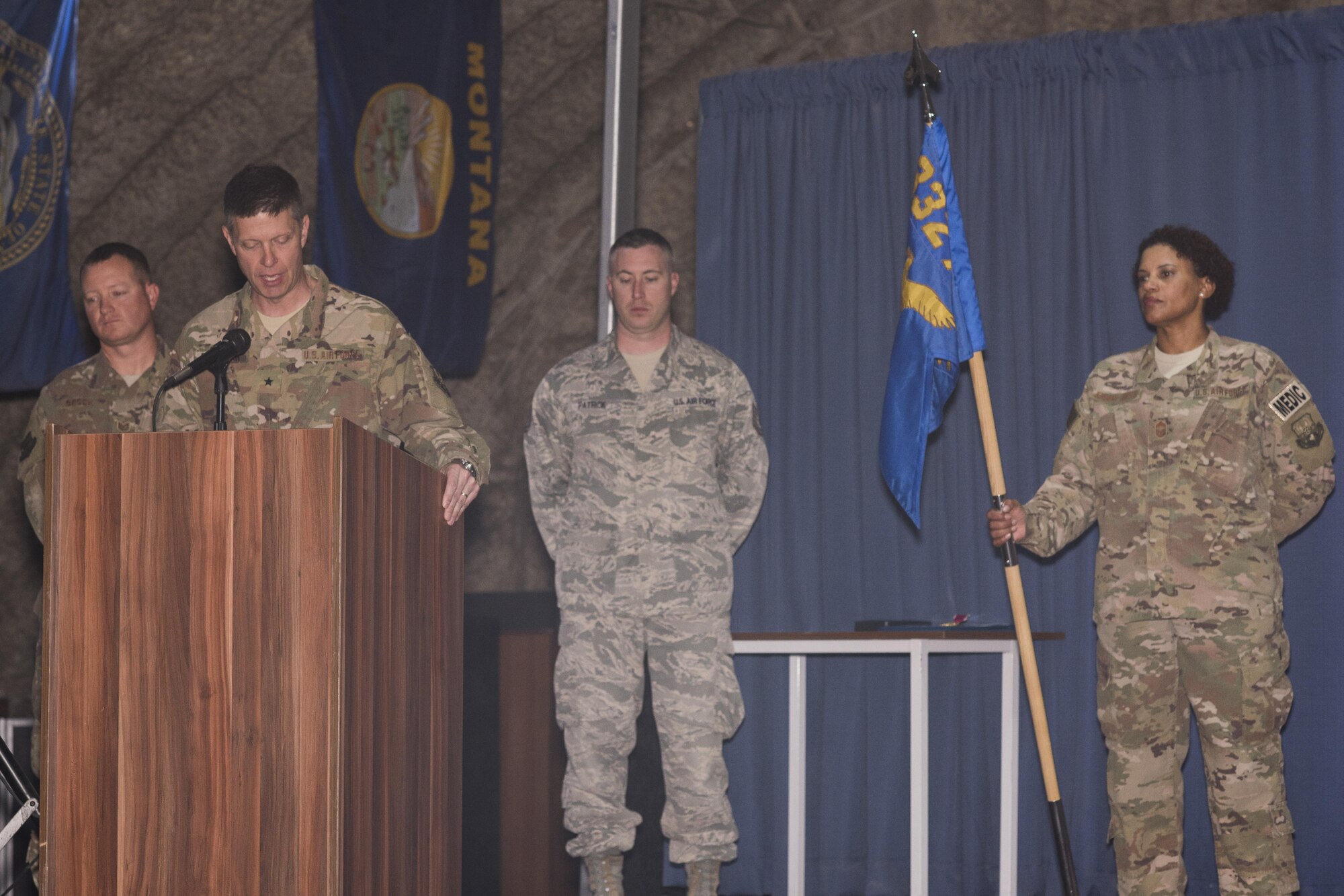 Brig. Gen. Kyle W. Robinson, 332nd Air Expeditionary Wing commander, left, talks to the audience during the 332nd Expeditionary Medical Group change of command ceremony June 3, 2017 in Southwest Asia. Robinson presided over the ceremony in which Col. Joseph V. Hale took command of the group from Col. Michelle A. Pufall. (U.S. Air Force photo/Senior Airman Damon Kasberg)