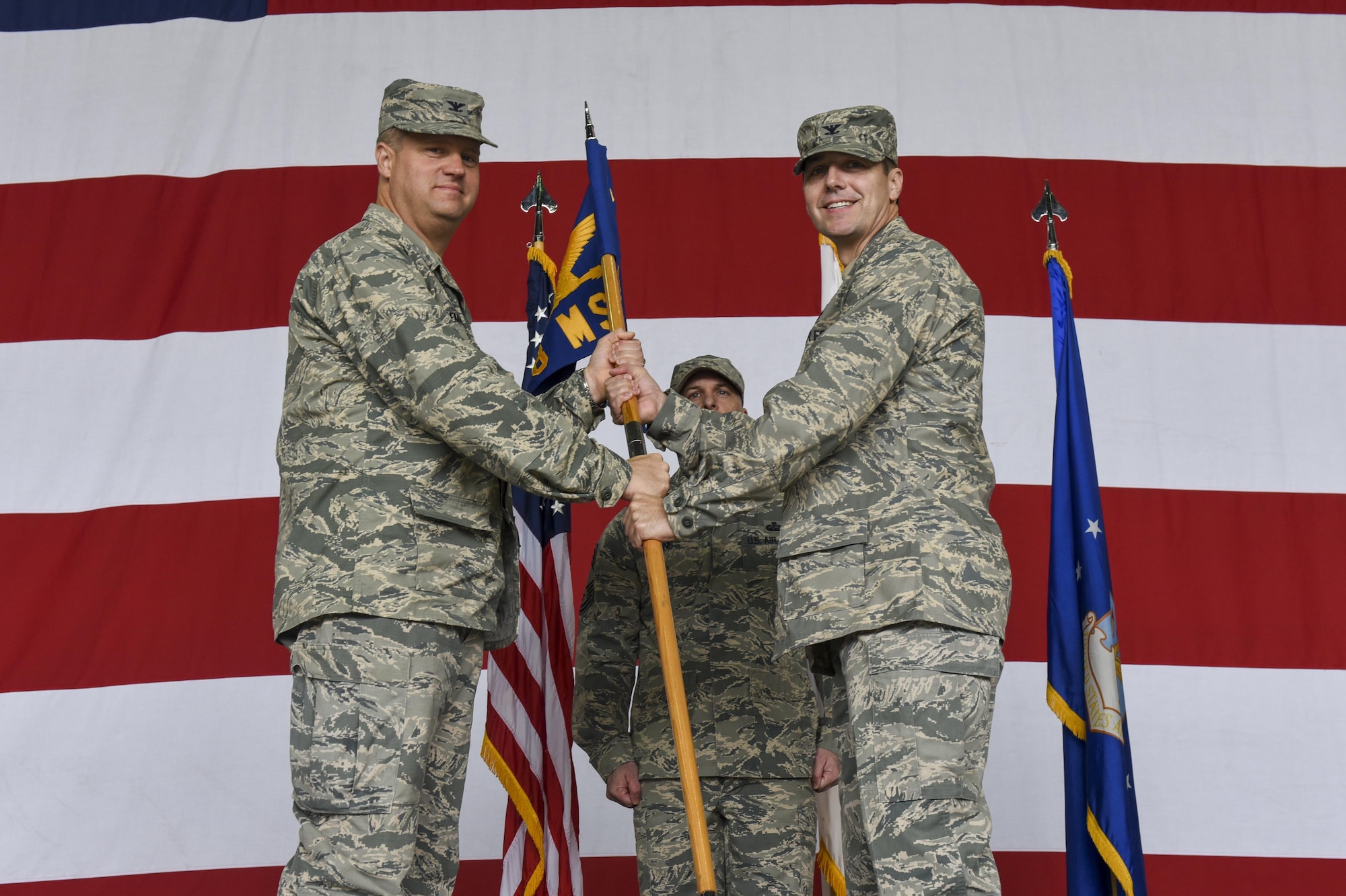 U.S. Air Force Col. Michael Zuhlsdorf, 8th Mission Support Group commander, receives the guidon from Col. David Shoemaker, 8th Fighter Wing commander, during a change of commander ceremony at Kunsan Air Base, Republic of Korea, June 8, 2017. Col. Shoemaker presided over the ceremony in which Col. Richard McKee relinquished command of the 8th MSG to Col. Michael Zuhlsdorf. (U.S. Air Force photo by Senior Airman Michael Hunsaker/Released)