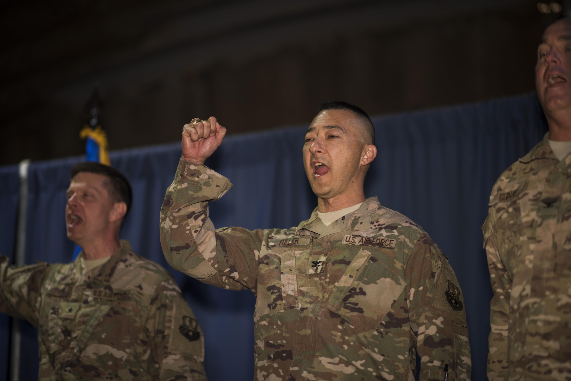Col. Christopher K. Fuller, Expeditionary Mission Support Group commander, sings the Air Force song during a change of command ceremony May 31, 2017 in Southwest Asia. Prior to taking command, Fuller was the Environmental Management Directorate deputy director at the Air Force Civil Engineer Center, in Joint Base San Antonio, Texas. (U.S. Air Force photo/Senior Airman Damon Kasberg)