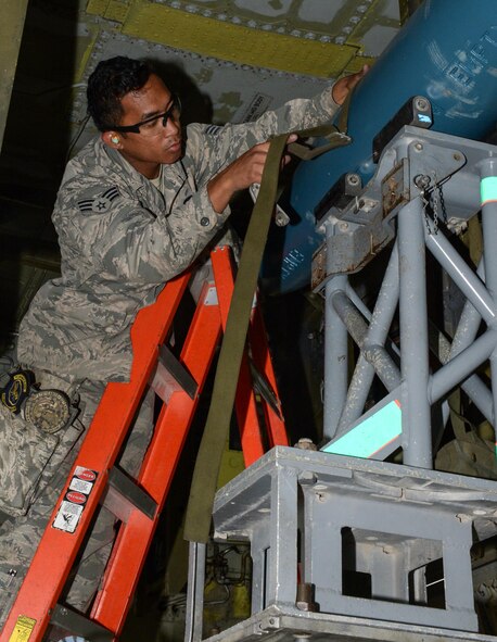 U.S. Air Force Senior Airman Aldrin Magalong, 2nd Aircraft Maintenance Squadron load crew team chief, secures BDU-50s (inert munitions) general purpose unguided conventional weapons to a bomb lift truck at RAF Fairford, U.K., June 5, 2017. Load crews are participating in Saber Strike 2017, an annual, multinational, exercise designed to strengthen interoperability and cohesiveness between NATO allies and partner nations. (U.S. Air Force photo/Senior Airman Curt Beach)