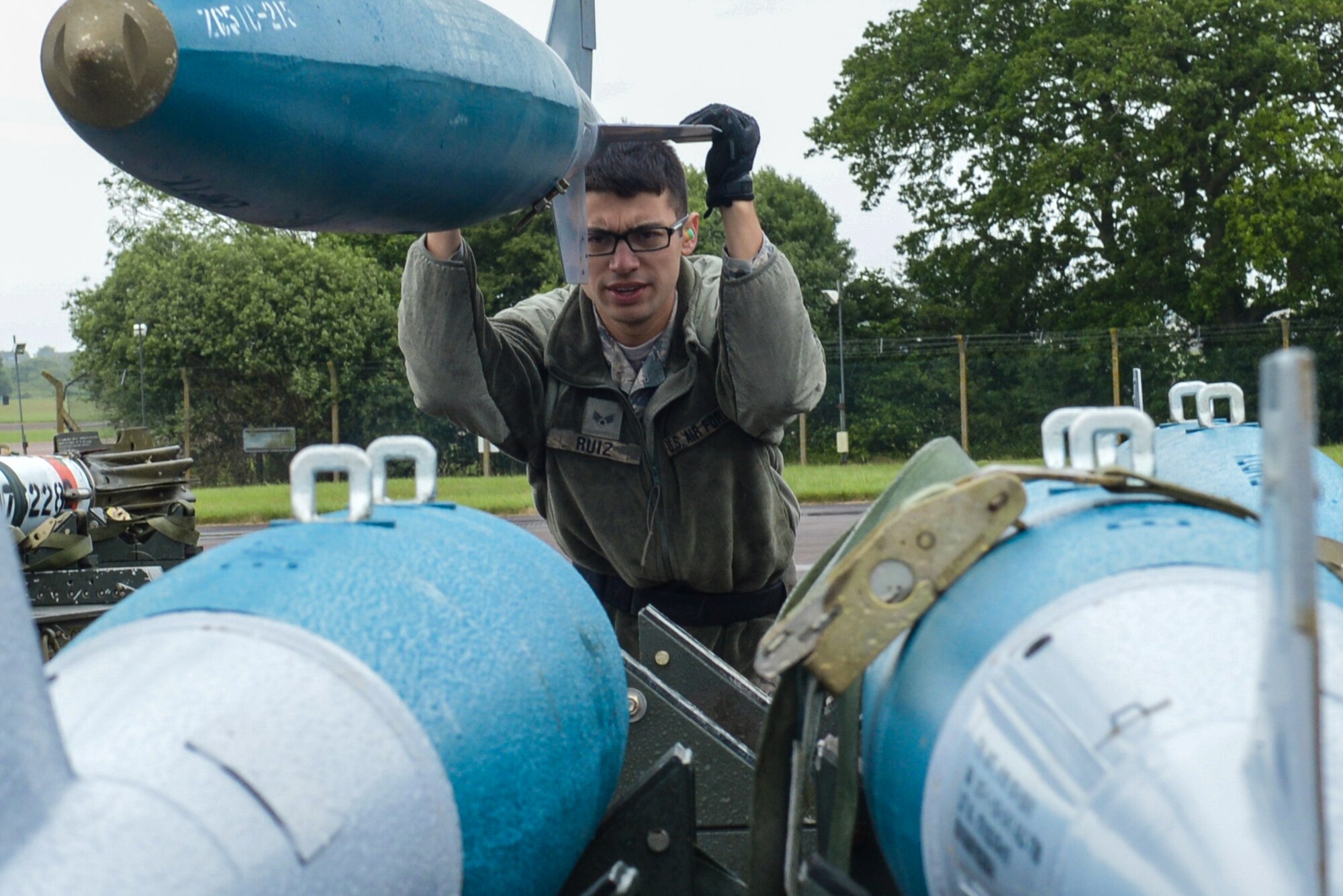 U.S. Air Force Senior Airman Michael Ruiz, 2nd Aircraft Maintenance Squadron load crew team member, guides BDU-50s (inert munitions) general purpose unguided conventional weapons at Royal Air Force Fairford, U.K., June 5, 2017. Load crews are participating in Saber Strike 2017, an annual, multinational, exercise designed to strengthen interoperability and cohesiveness between NATO allies and partner nations. (U.S. Air Force photo/Senior Airman Curt Beach)