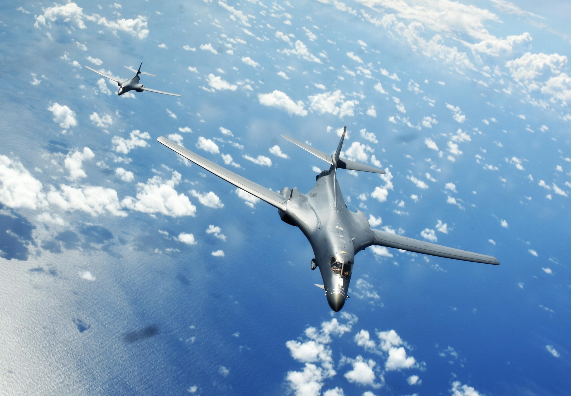 Two U.S. Air Force B-1B Lancers assigned to the 9th Expeditionary Bomb Squadron, deployed from Dyess Air Force Base, Texas, fly a 10-hour mission from Andersen Air Force Base, Guam, through the South China Sea, operating with the U.S. Navy's Arleigh Burke-class guided-missile destroyer USS Sterett (DDG 104), June 8, 2017. The joint training, organized under Pacific Command's continuous bomber presence program (CBP), allows the Air Force and Navy to increase interoperability by refining joint tactics, techniques and procedures while simultaneously strengthening their ability to seamlessly integrate their operations. (U.S. Air Force photo/Tech. Sgt. Richard P. Ebensberger)