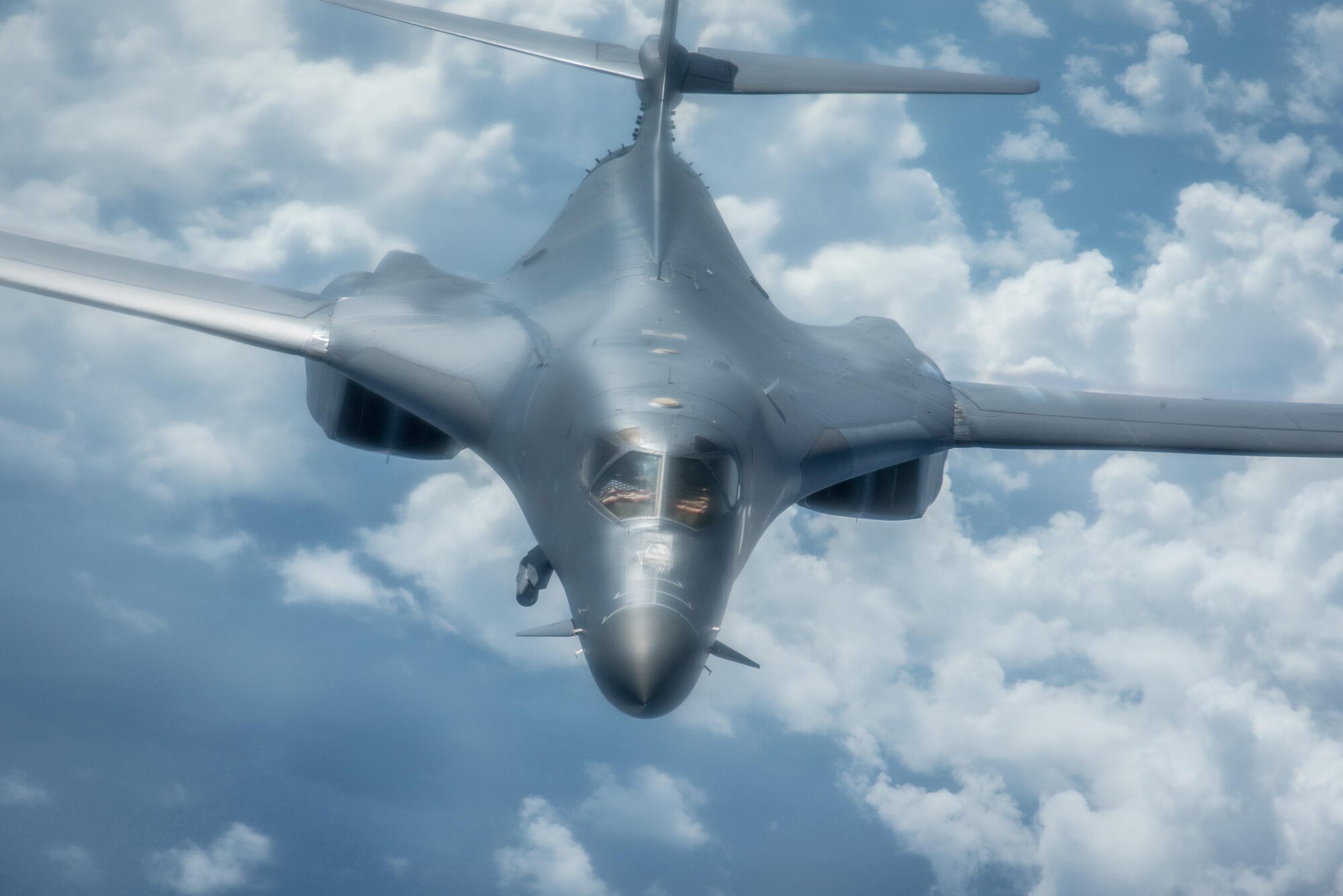 A U.S. Air Force B-1B Lancer assigned to the 9th Expeditionary Bomb Squadron, deployed from Dyess Air Force Base, Texas, flies a 10-hour mission from Andersen Air Force Base, Guam, through the South China Sea, operating with the U.S. Navy's Arleigh Burke-class guided-missile destroyer USS Sterett (DDG 104), June 8, 2017. The joint training, organized under Pacific Command's continuous bomber presence program (CBP), allows the Air Force and Navy to increase interoperability by refining joint tactics, techniques and procedures while simultaneously strengthening their ability to seamlessly integrate their operations. (U.S. Air Force photo/Staff Sgt. Joshua Smoot)