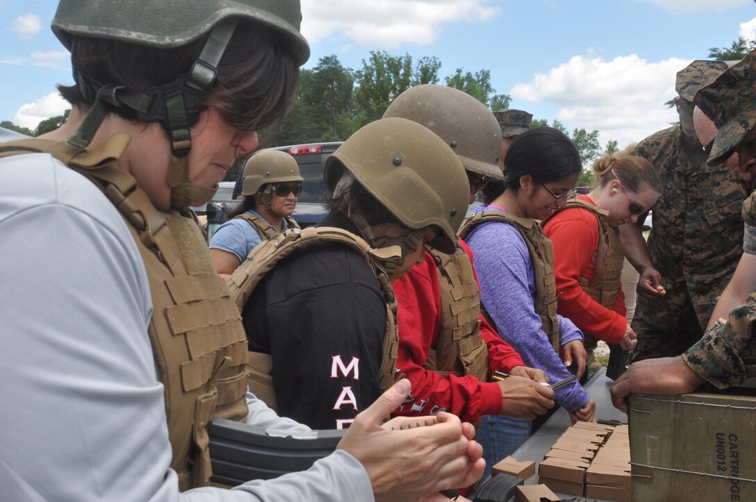 Marine spouses learn how to load magazines in preparation for live fire.