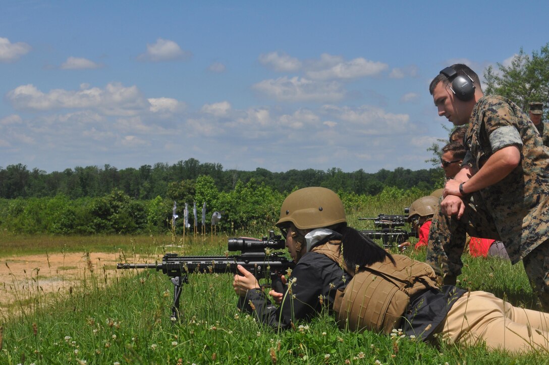 Marine spouses take to the firing line at the range for a live fire exercise.