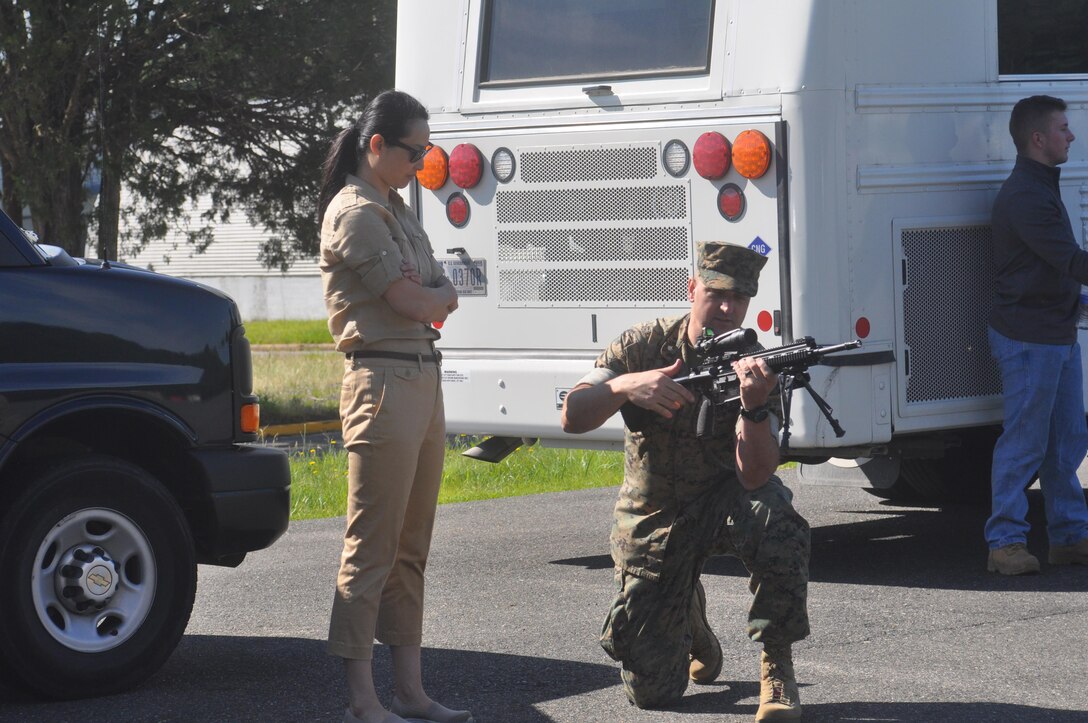 Sheila Wilbur getting pointers on the M-240 medium machine gun from her husband Lt. Col. Micheal Wilbur.