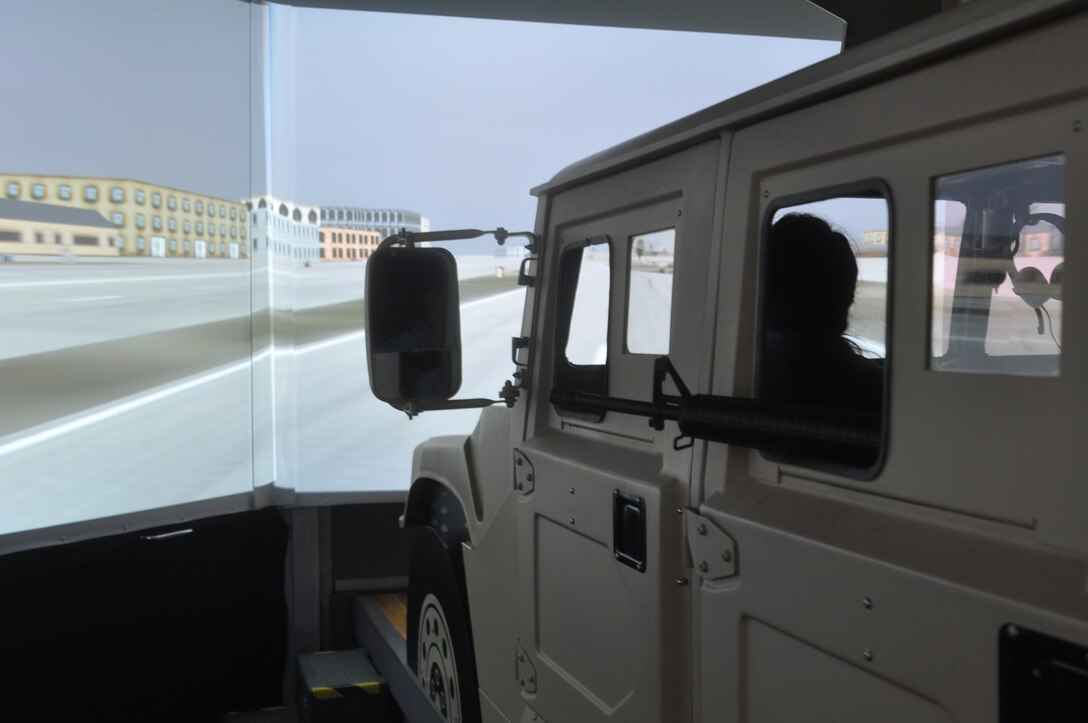 The spouses, in a Humvee, attempt to remain in a convoy while being attacked by the enemy,  while in the convoy simulator.