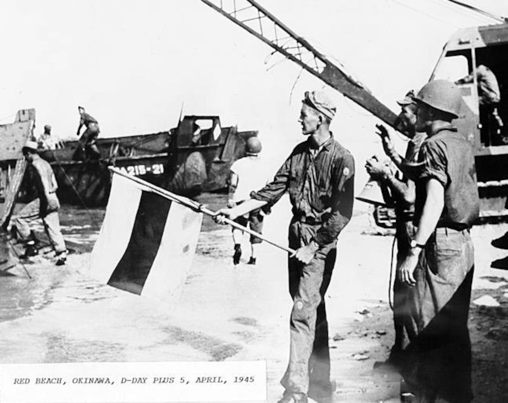 Red Beach, Okinawa, D-Day Plus 5 April 1945
WWII

Uniform: Dungarees, the Coast Guard signalman holding the signal flag is Wilbur Selbrede.  The photo was taken on Okinawa on D-Day +5.
