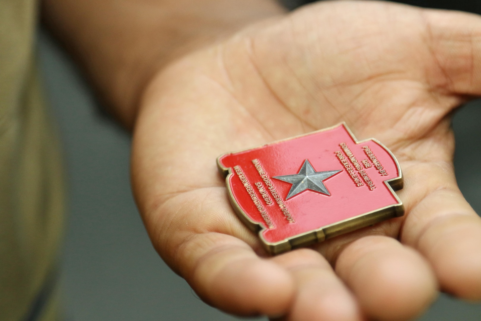 vt. Mohammad Nadir holds a challenge coin given to him by Marine Corps Gen. William Jurney, commanding general for Western Recruiting Region, Marine Corps Recruiting Command, June 1, 2017. Nadir graduated from recruit training on May 26, 2017, and will train to become an infantryman. Nadir moved to the United States in 2014 with a Special Immigrant Visa after working for three years as an interpreter with the International Security Assistance Force in the Sangin District of Helmand province, Afghanistan. (U.S. Marine Corps photo by Sgt. Jessica Quezada)