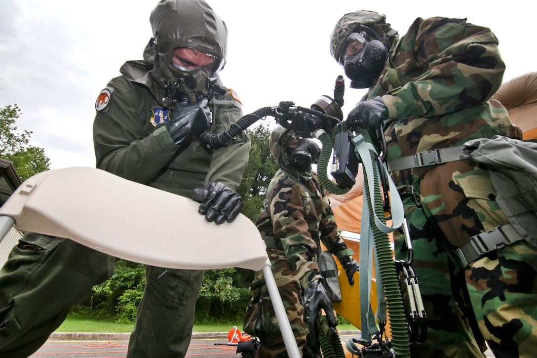 New Jersey Air National Guard 1st Lt. Beau Deleon, left, processes through the aircrew contamination control area during an exercise at Joint Base McGuire-Dix-Lakehurst, N.J., June 7, 2017. Deleon is a pilot assigned to the 141st Air Refueling Squadron. Air National Guard photo by Master Sgt. Matt Hecht 