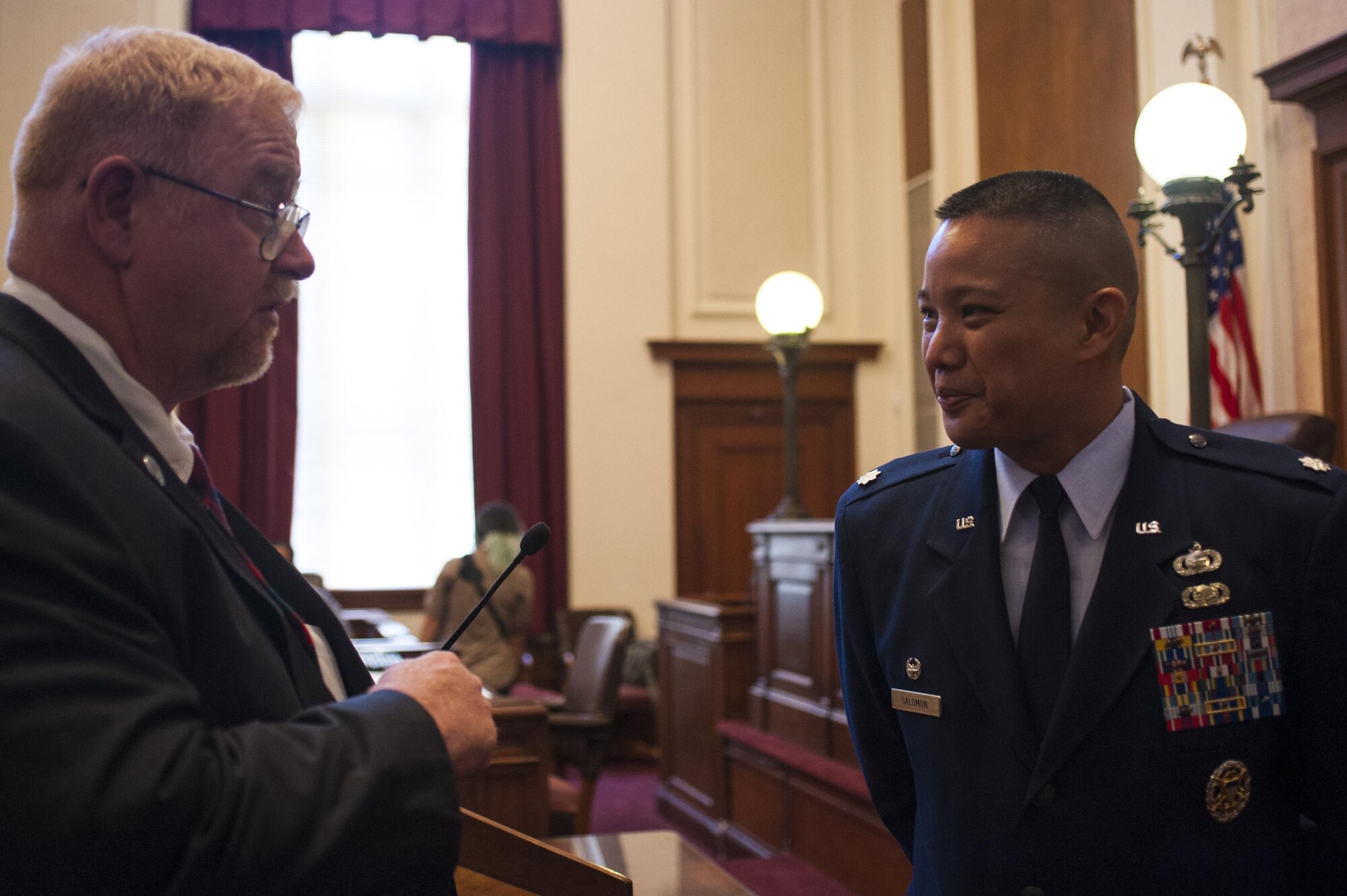 Eric Holman, San Angelo court district adjudications officer, talks with Lt. Col. Abraham Salomon, 17th Training Support Squadron commander, at the the naturalization ceremony in the O.C. Fisher Building, San Angelo, Texas, June 7, 2017. Solomon is a first generation immigrant from the Philippines. (U.S. Air Force photo by Senior Airman Scott Jackson/Released)