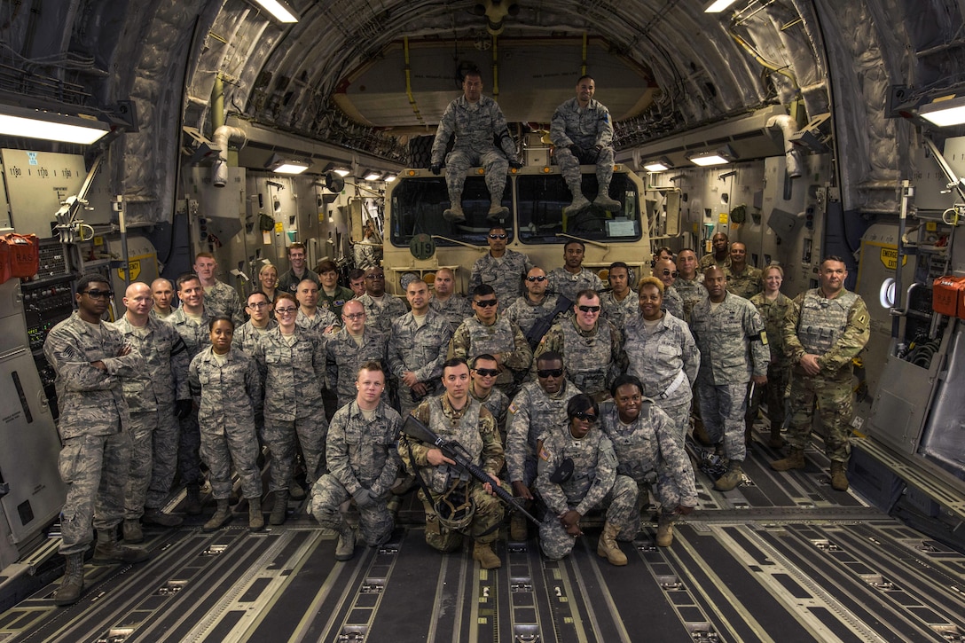 U.S. Air Force Aerial Porters with the 35th Aerial Port Squadron, 514th Air Mobility Wing; Loadmasters with the 732nd Airlift Squadron, 514th Air Mobility Wing, along with Soldiers with the 851st Transportation Detachment, U.S. Army Reserve, pose for a group photo after a joint mobility exercise at Joint Base McGuire-Dix-Lakehurst, N.J., June 4, 2017. The aerial porters loaded two Humvees and a Heavy Expanded Mobility Tactical Truck Recovery Truck onboard a C-17, which is assigned to the 305th Air Mobility Wing and is maintained and flown by the 514th Air Mobility Wing, Air Force Reserve Command. (U.S. Air Force photo by Master Sgt. Mark C. Olsen/Released)