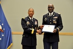 DLA Troop Support Commander Army Brig. Gen. Charles Hamilton, left, presents Army Lt. Col. Timothy N. Holloway with a certificate of appreciation during a retirement ceremony in Holloway’s honor June 4, 2017 in Philadelphia. Holloway retired after 32 years of active and reserve duty. 