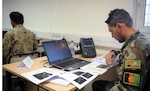 KABUL, Afghanistan (June 7, 2017) —1st Lt. Ahmad Shoaib Nabizada, honorary graduate, looks at his notes during the Spectrum Management class. The Afghan National Defense and Security Forces are to integrate its newest graduates in communication operations. These soldiers will be responsible for generating and ensuring accurate radio frequency signals, essential for combat operations, rescue missions and logistic support. (U.S. Navy photo by Lt. j.g. Egdanis Torres Sierra, Resolute Support Public Affairs – Afghanistan)