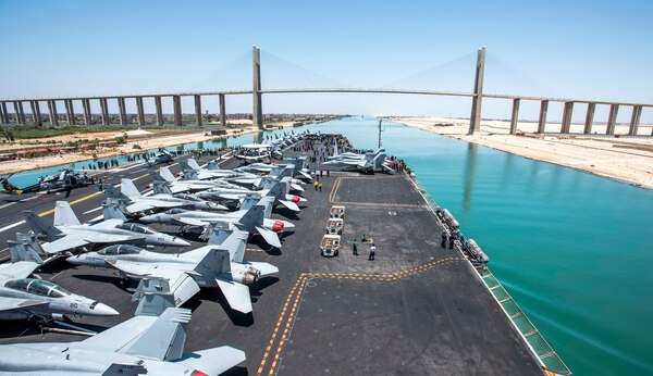 170605-N-YL257-053 SUEZ CANAL (June 5, 2017) The aircraft carrier USS George H.W. Bush (CVN 77) prepares to sail under the International Peace Bridge as it transits the Suez Canal. George H.W. Bush is deployed in the U.S. 5th Fleet area of operations in support of maritime security operations designed to reassure allies and partners, and preserve the freedom of navigation and the free flow of commerce in the region. (U.S. Navy photo by Mass Communication Specialist 2nd Class Christopher Gaines/Released)
