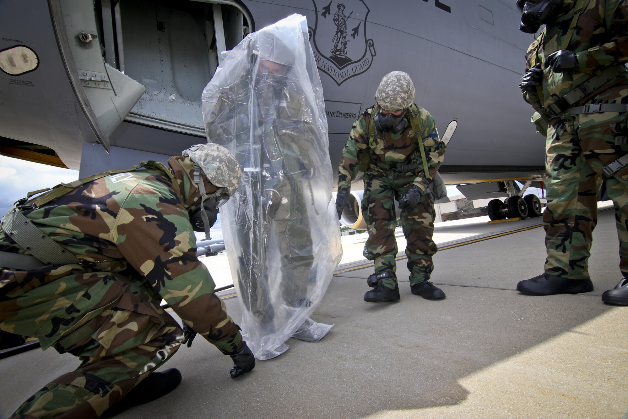 U.S. Air Force maintenance airmen from the New Jersey Air National Guard's 108th Wing place 1st Lt. Beau Deleon into a protective covering during an exercise at Joint Base McGuire-Dix-Lakehurst, N.J., June 7, 2017. Deleon is a KC-135 Stratotanker pilot with the 141st Air Refueling Squadron. (U.S. Air National Guard photo by Master Sgt. Matt Hecht/Released)