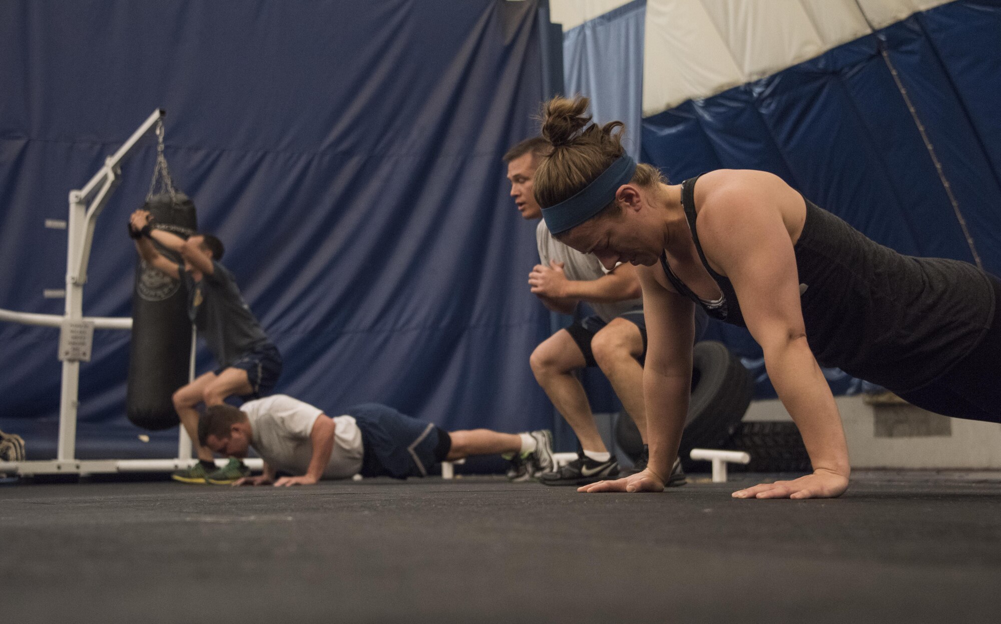419th Fighter Wing Airmen do pushups and air squats June 3 at Hill Air Force Base’s Hess Fitness Center as part of The Murph Challenge, which consists of a one-mile run followed by 100 pullups, 200 pushups, 300 air squats and ends with another mile run. (U.S. Air Force photo/Senior Airman Justin Fuchs)