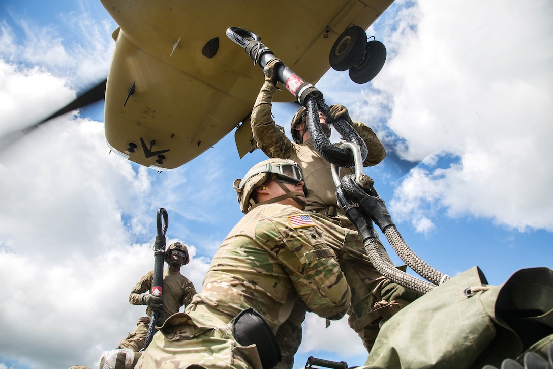 Solders attach an M777A2 Howitzer to a CH-47 Chinook helicopter during slingload training during exercise Saber Strike 2017, at Bemowo Piskie Training Area near Orzysz, Poland, June 7, 2017. Army photo by Spc. Stefan English