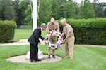 Naval Surface Warfare Center, Carderock Division Technical Director Dr. Tim Arcano (left), Commanding Officer Capt. Mark Vandroff and Lt. Cmdr. Jon Burrow carry a wreath while Sailors stand at attention in honor of those who have died in service of the country during a Memorial Day ceremony May 30, 2017, at the West Bethesda, Maryland, headquarters. (U.S. Navy photo by Kristin Behrle/Released)