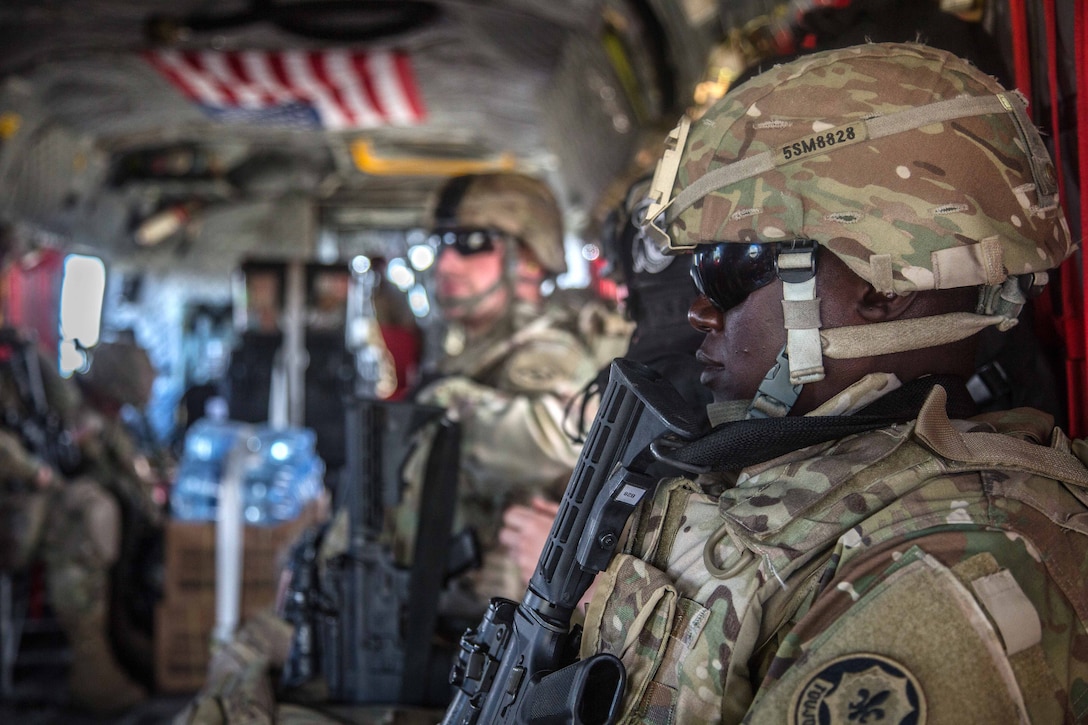 Solders wait to offload from a CH-47 Chinook helicopter during exercise Saber Strike 2017, at Bemowo Piskie Training Area near Orzysz, Poland, June 7, 2017. Army photo by Spc. Stefan English