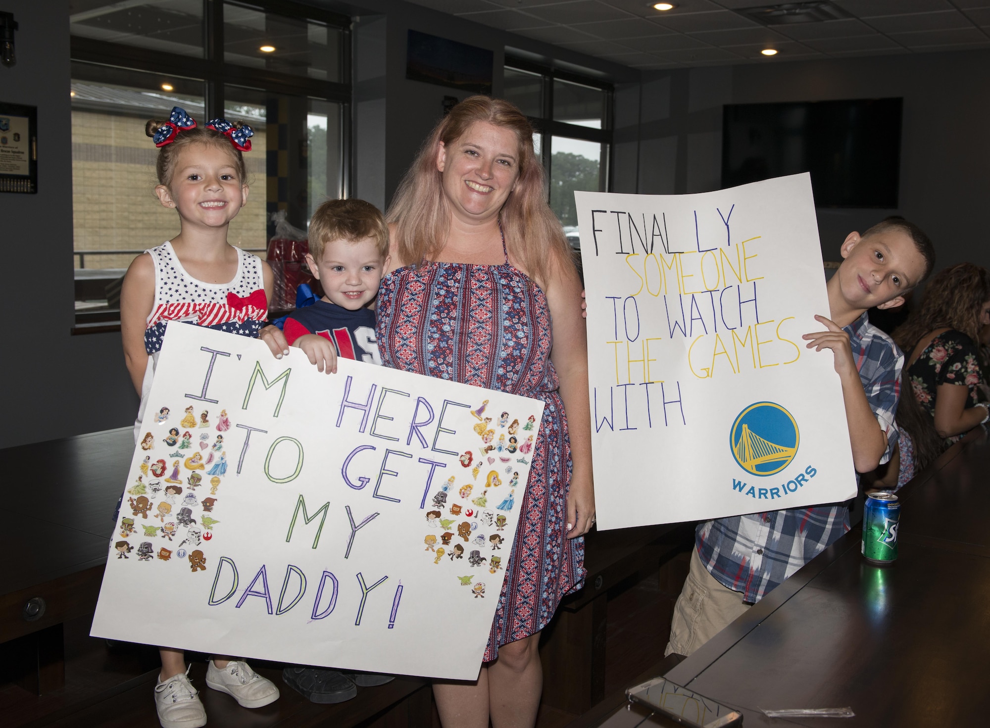 Family and friends hold signs during a redeployment, June 6, 2017, at Moody Air Force Base, Ga. The 41st and 71st Rescue Squadrons were recently deployed to Southwest Asia where they provided combat search and rescue capabilities in support of Operation Inherent Resolve. (U.S. Air Force photo by Airman 1st Class Lauren M. Sprunk)