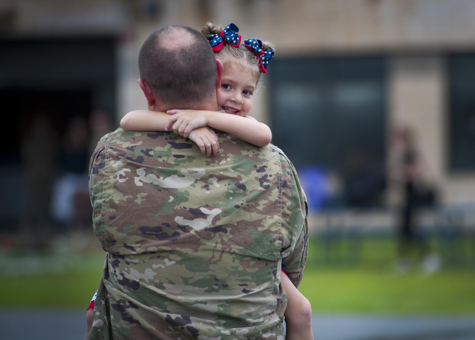 Staff Sgt. Matthew Pearson, 71st Aircraft Maintenance Unit navigation specialist, holds his daughter, Savannah, during a redeployment, June 6, 2017, at Moody Air Force Base, Ga. The 41st and 71st Rescue Squadrons were recently deployed to Southwest Asia where they provided combat search and rescue capabilities in support of Operation Inherent Resolve. (U.S. Air Force photo by Airman 1st Class Lauren M. Sprunk)