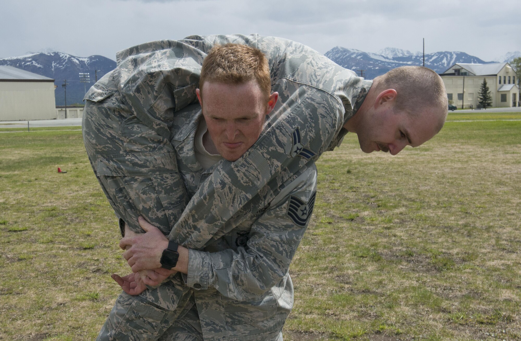 Tech. Sgt. Joshua Hefley, 673d Security Forces Squadron Falcon Flight sergeant carries Airman 1st Class Jared Brazil through a cone course May 25, 2017, at the Elmendorf Fitness Center. For 30 days, Hefley and five others trained to prepare for the 2017 Pacific Air Forces Advanced Combat Skills Assessment. 