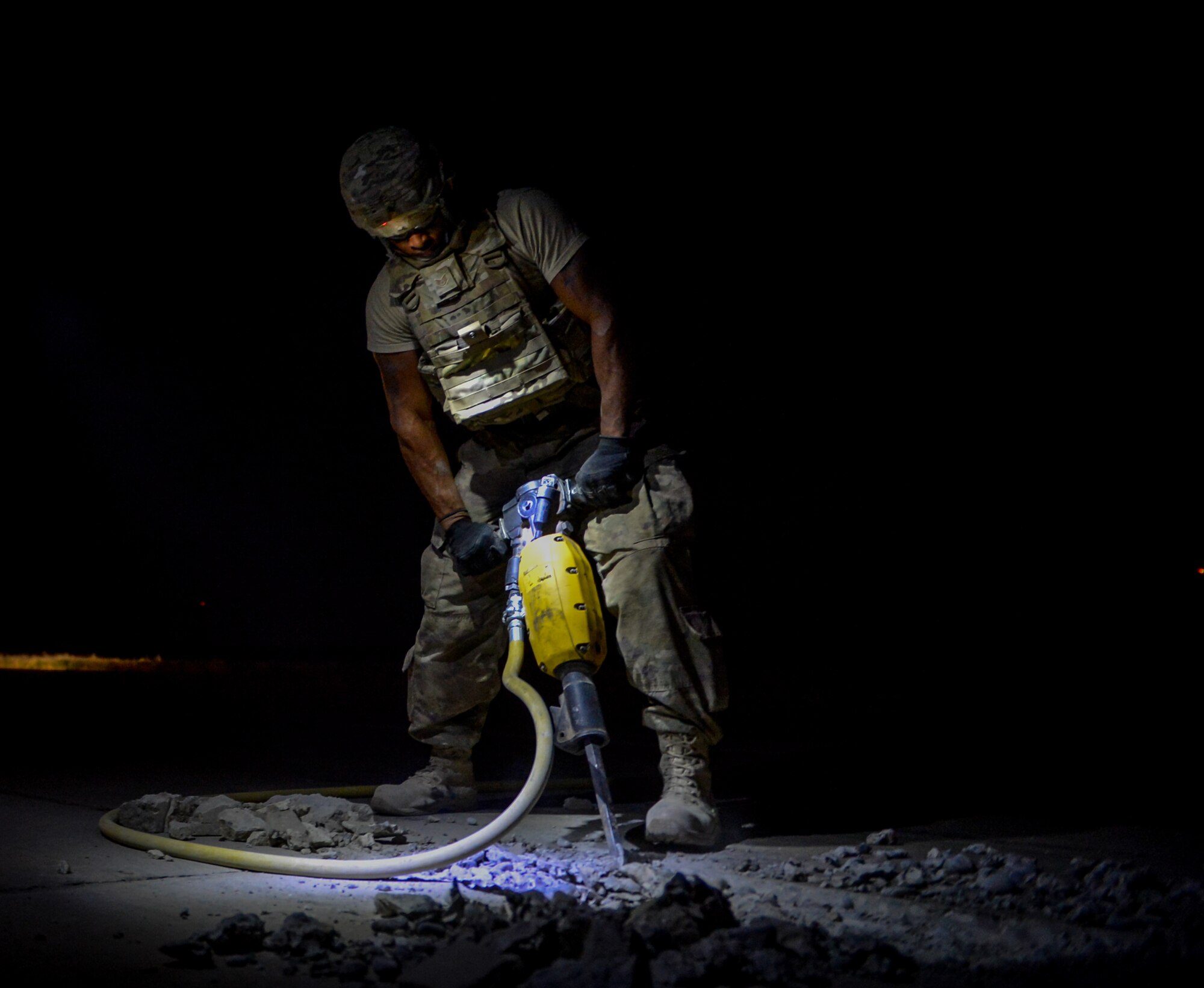 A member of the 1st Expeditionary Civil Engineer Group jackhammers a damaged section of the flightline at Qayyarah West Airfield during a restoration project May 16, 2017. Qayyarah West is an airfield in northern Iraq’s Ninawa Province and serves as the logistical hub and strategic launching pad resupplying the frontlines in an attempt to recapture Mosul. (U.S. Air Force photo by Staff Sgt. Michael Battles)
